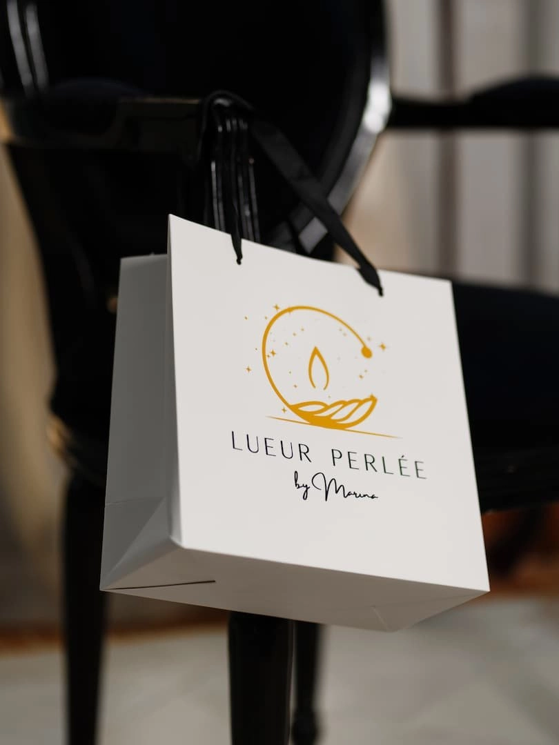 Sac shopping petit modèle en présentation sur la bras d'une chaise.